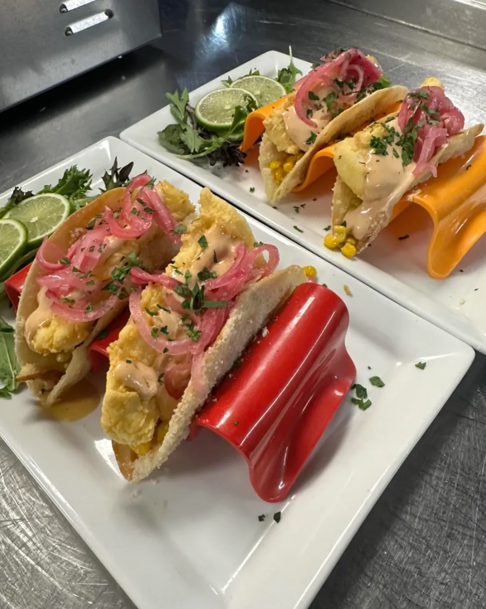 Fried fish tacos with pickled red onion and lime